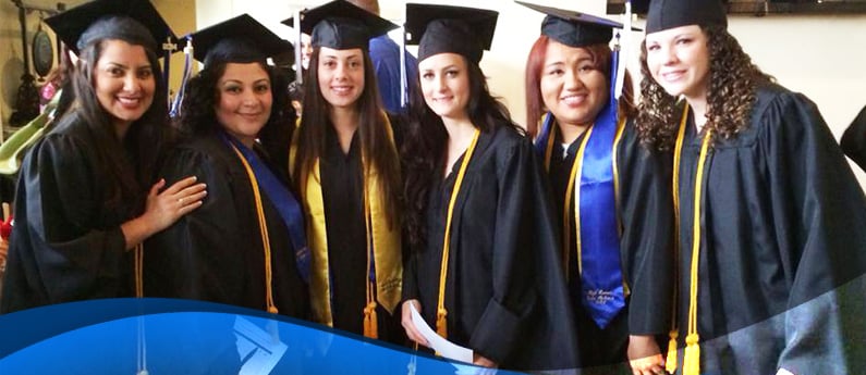 South Coast College Students graduating and are posing in their caps and gowns.