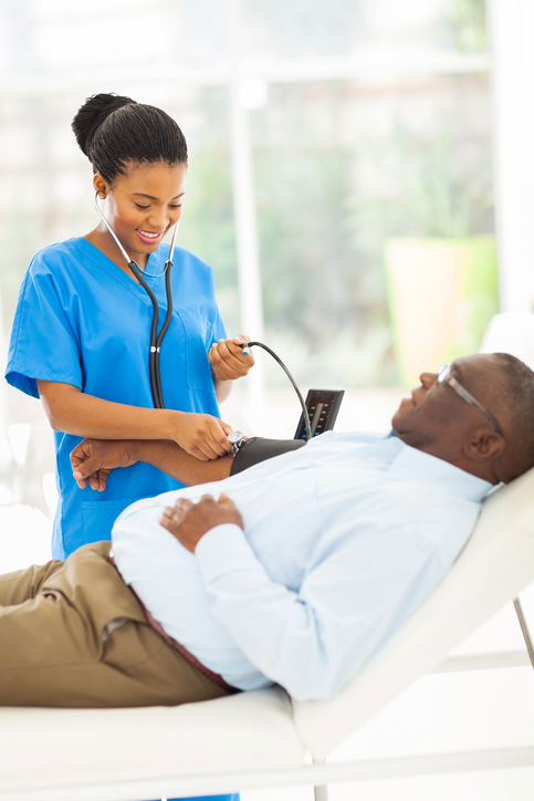 A medical assistant taking vital signs